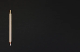 white pencil on black platform