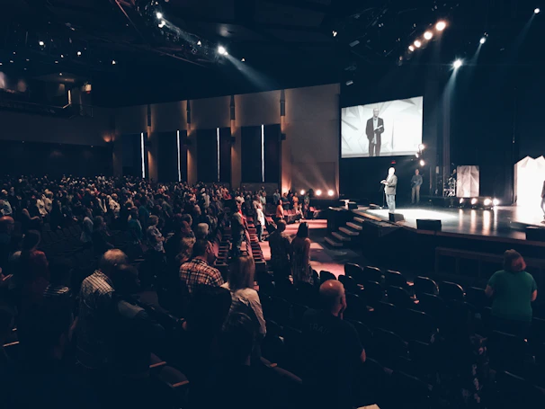 An inspiring keynote speaker addressing a large, attentive audience at a WBC event