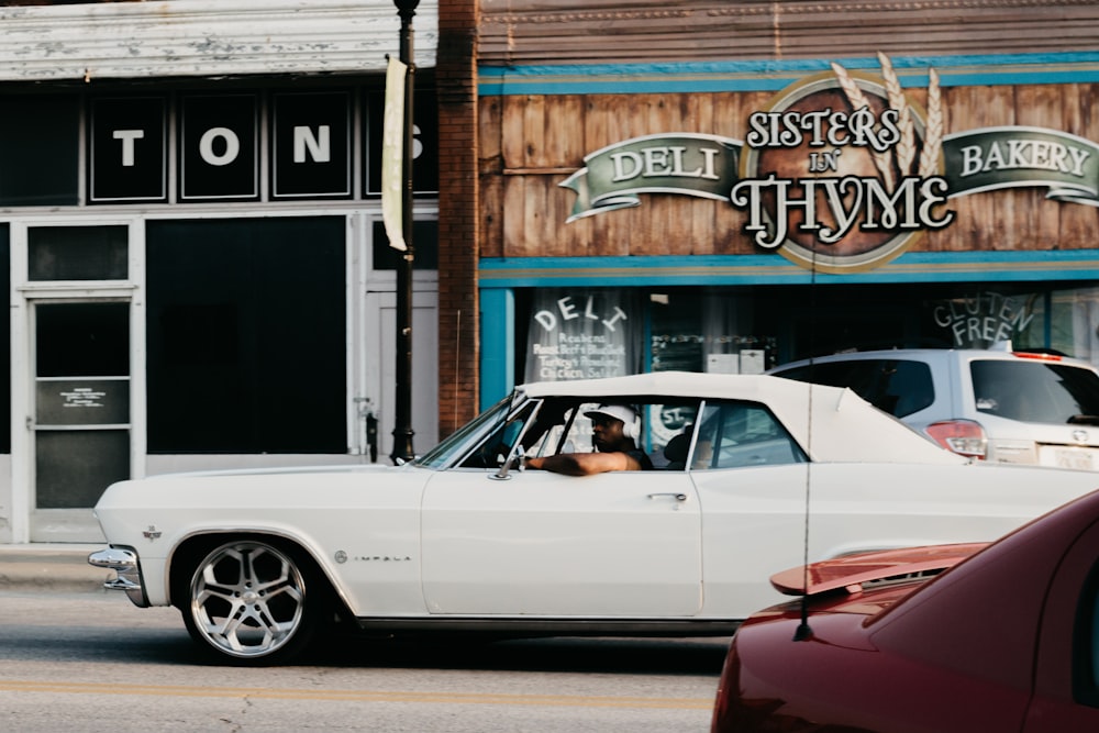 person riding on a white coupe