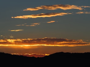 Sunset view over the hills surrounding Monte San Juan, highlighting the natural beauty of the district.