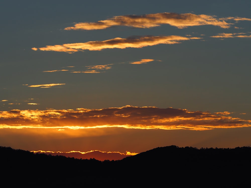 silhouette of mountain during sunset photo