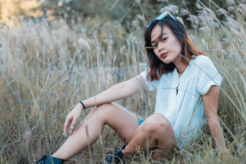 woman sitting on grass field