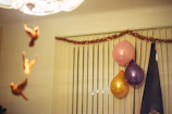 Soft pastel-colored fabric birds hanging gently from a mobile in a child's room