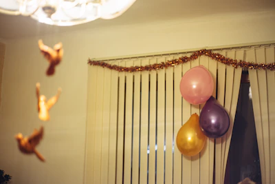Soft pastel-colored fabric birds hanging gently from a mobile in a child's room