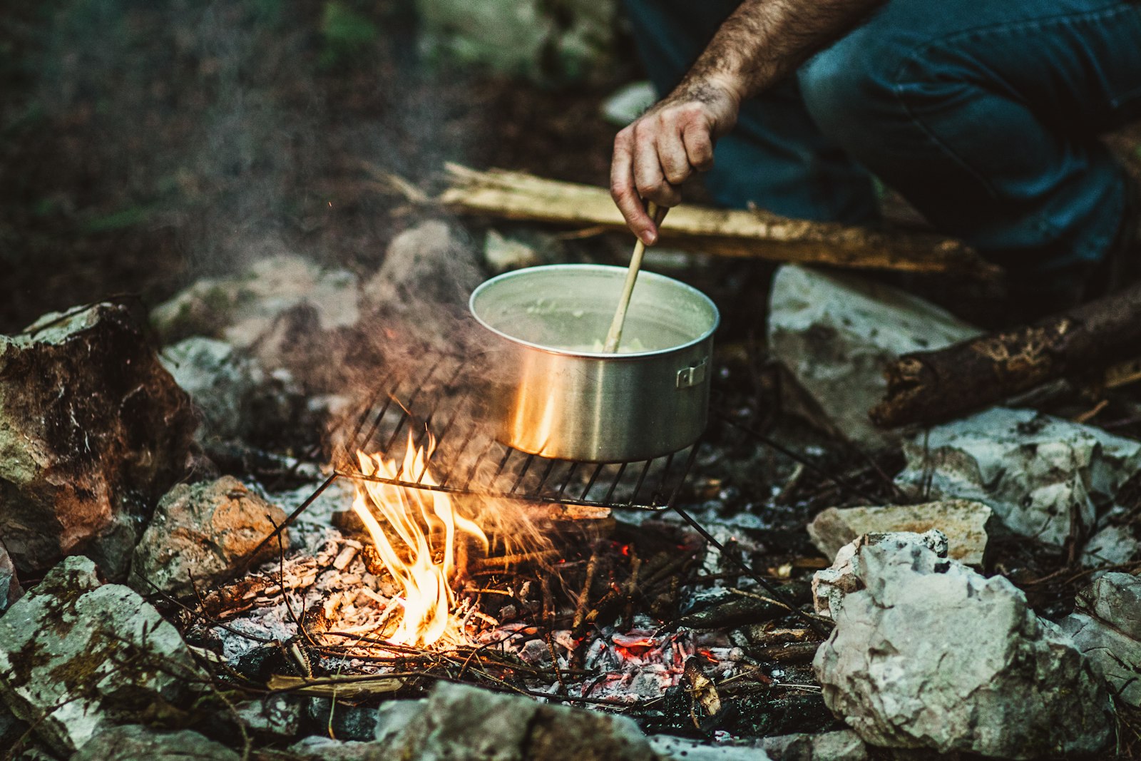 Canon EOS 7D Mark II + Canon EF 85mm F1.8 USM sample photo. Person cooking on bonefire photography