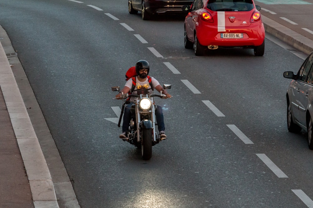 man riding on motorcycle on road