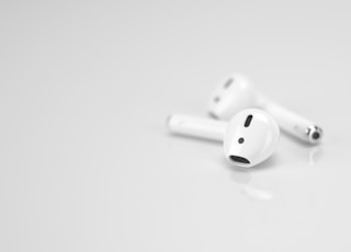 Apple AirPods on white surface