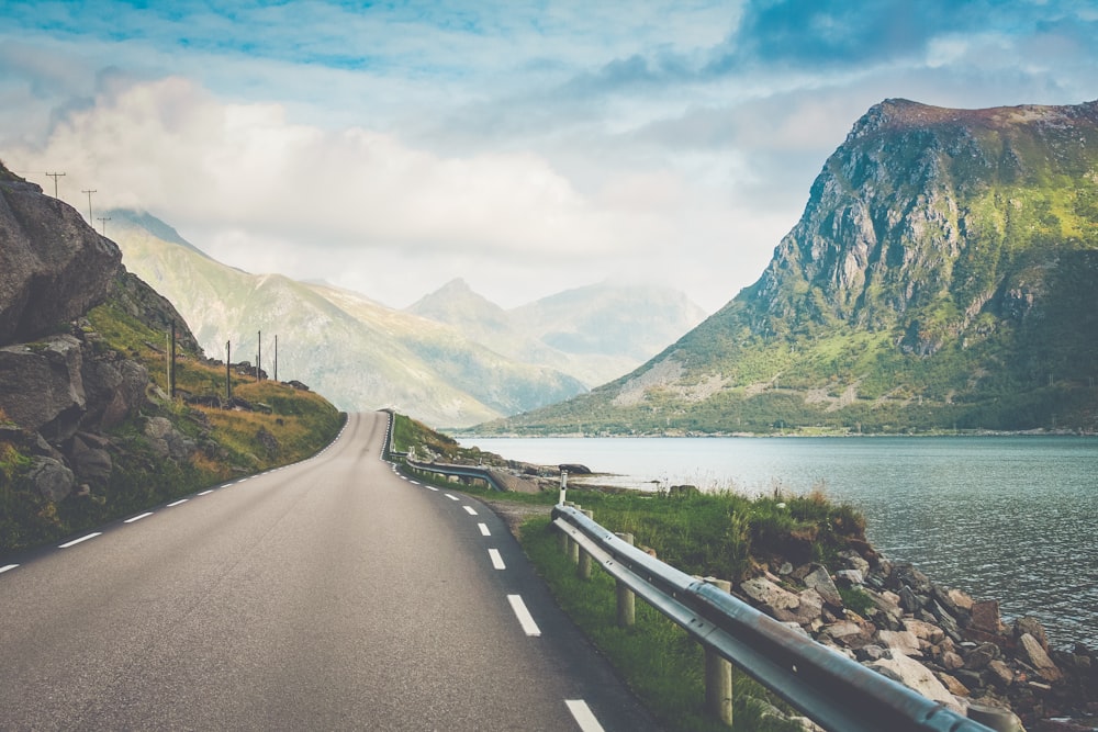 empty road beside body of water