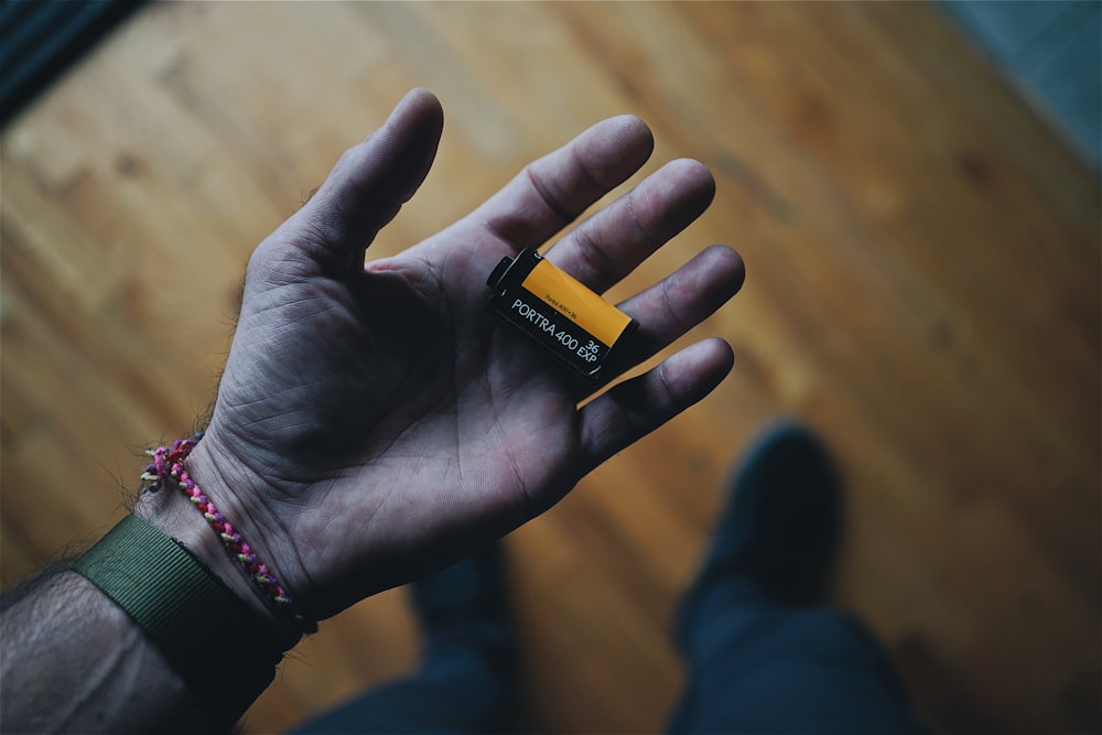 black camera film on person's hand