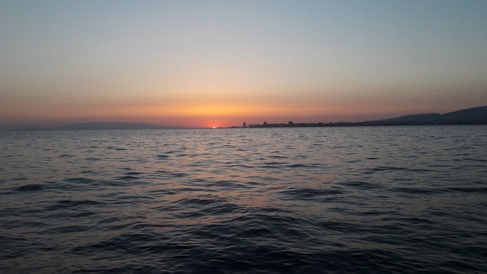 body of water during sunset