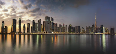 A panoramic view of Calgary’s modern downtown skyline at sunset.