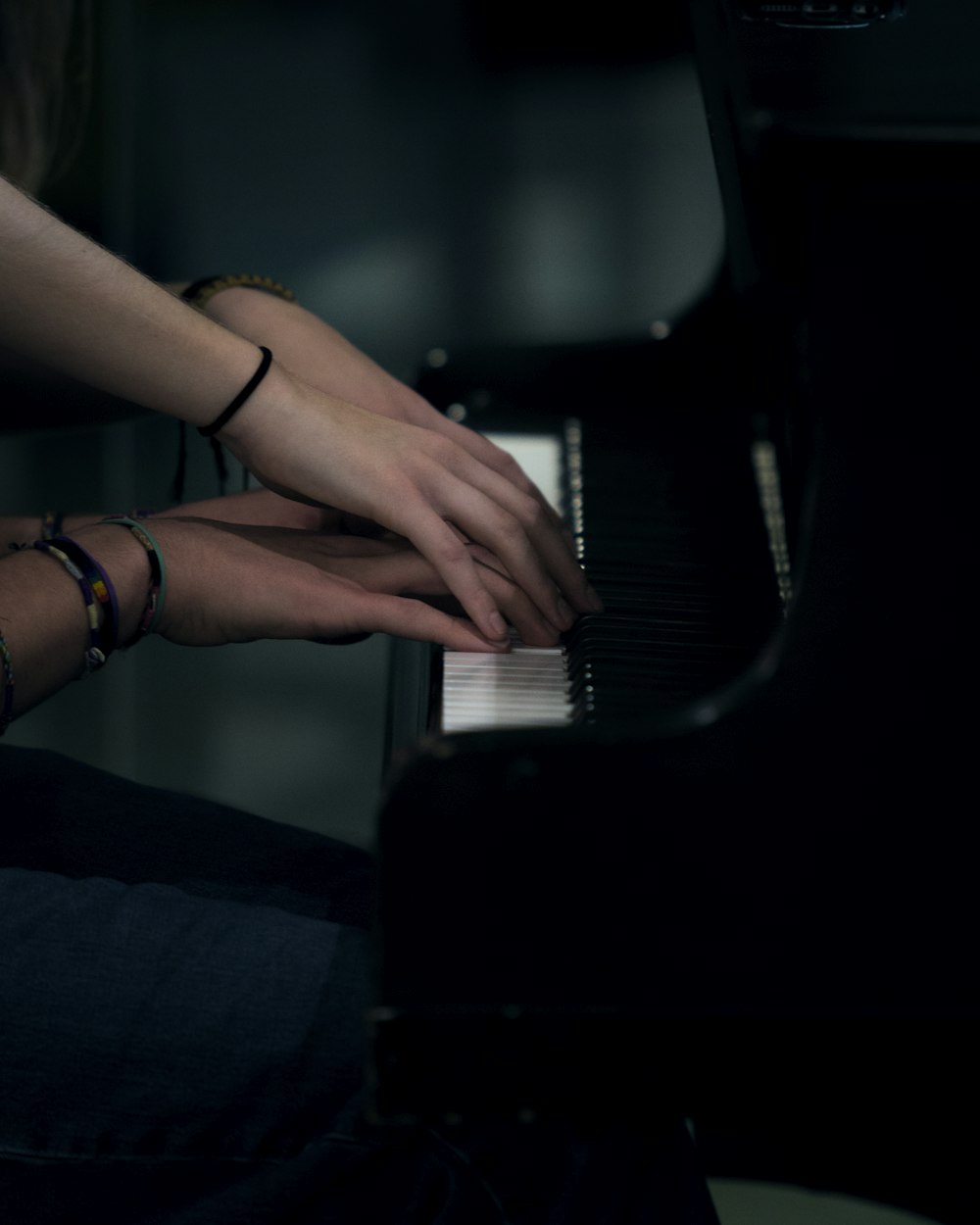 two person playing piano