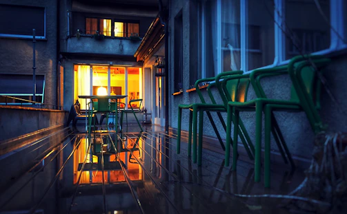 An outdoor patio glowing with subtle green and white lighting during twilight.