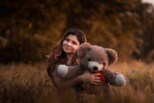woman holding brown bear in Caracal Romania