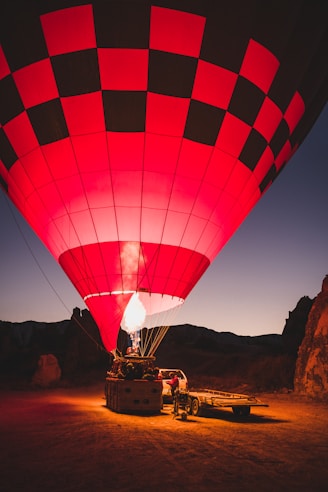 red and black hot air balloon on ground