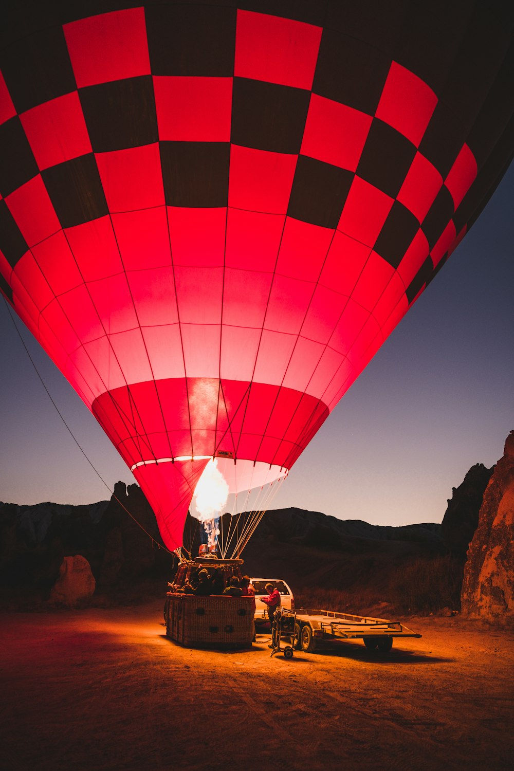 red and black hot air balloon on ground