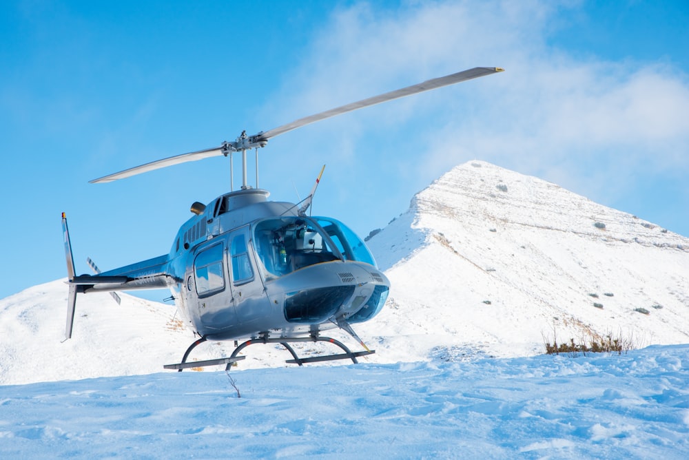 gray helicopter on mountain
