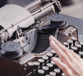 person typing using typewriter