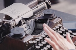 person typing using typewriter