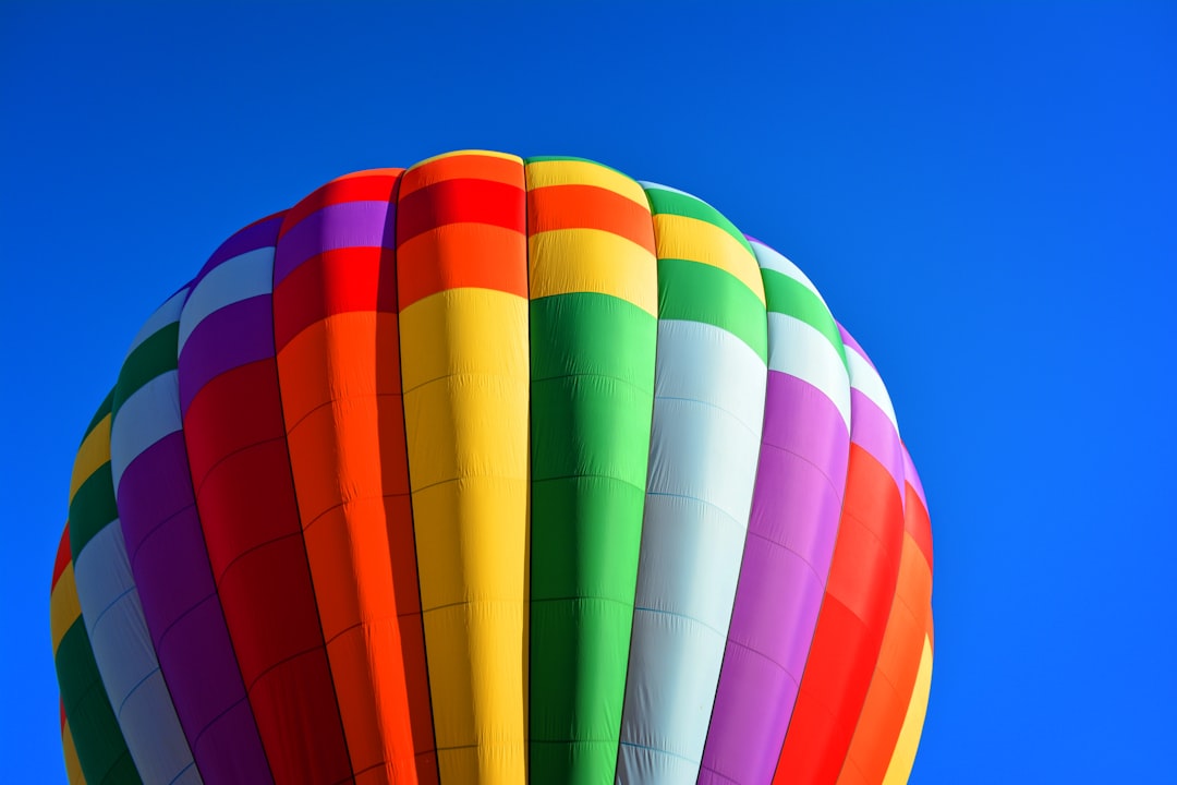time lapse photography of hot air balloon, It was one of those days when I was passing by a nice town in Connecticut. I stopped for coffee and, out of the sudden, big balloons began to shoot up for the sky, just behind the bushes and trees.