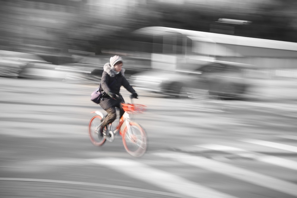 timelapses photo of woman riding bibycle