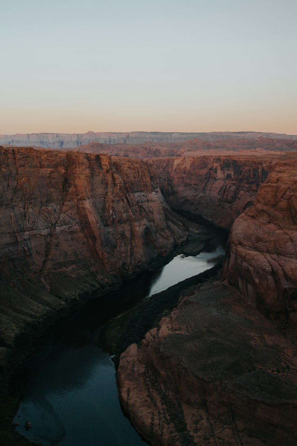 aerial photography of body of water between mountain