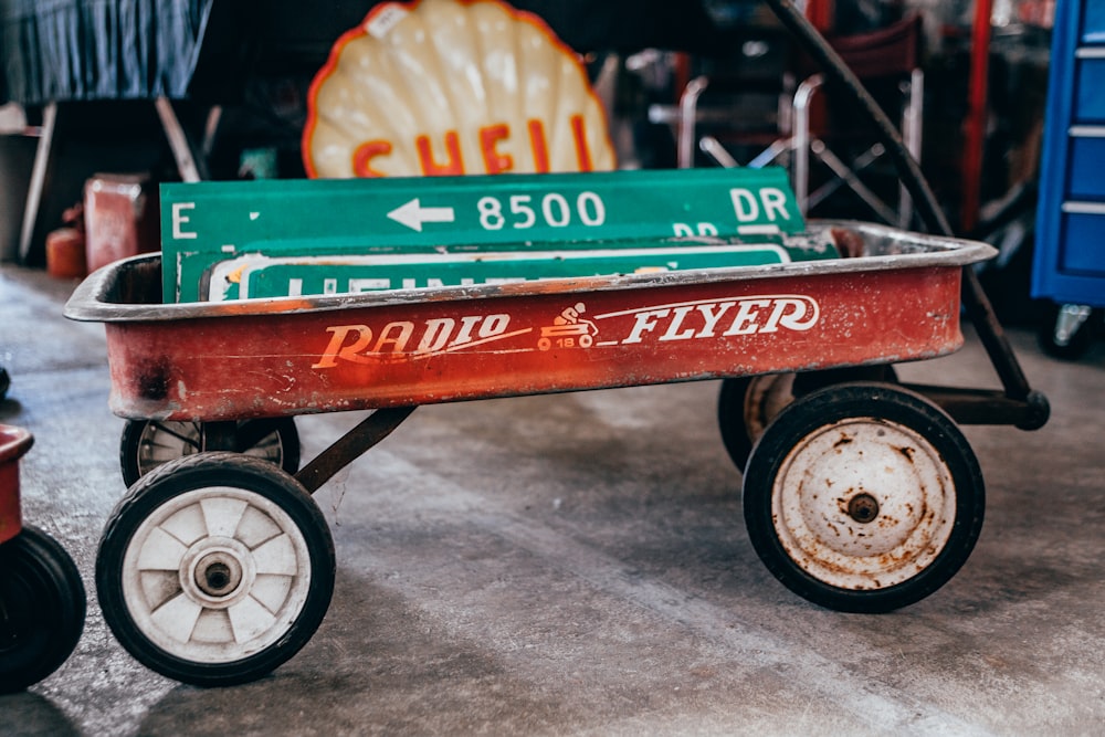 green street signage on red pull wagon