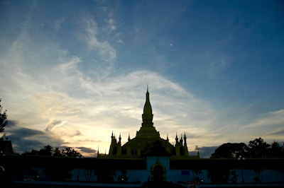 Dark clouds looming over a famous Thai temple at dusk.