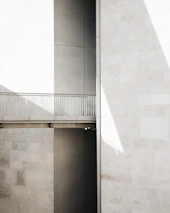 Minimalist architectural feature showcasing sharp contrasts between light and shadow in a high-end space.