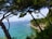 A serene view of a coastal property in the Canary Islands, showcasing vibrant blue waters and lush greenery.
