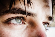 close up photo of gray-eyed man