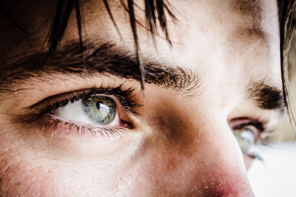 close up photo of gray-eyed man