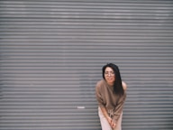 woman leaning on gray garage door