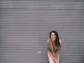 woman leaning on gray garage door