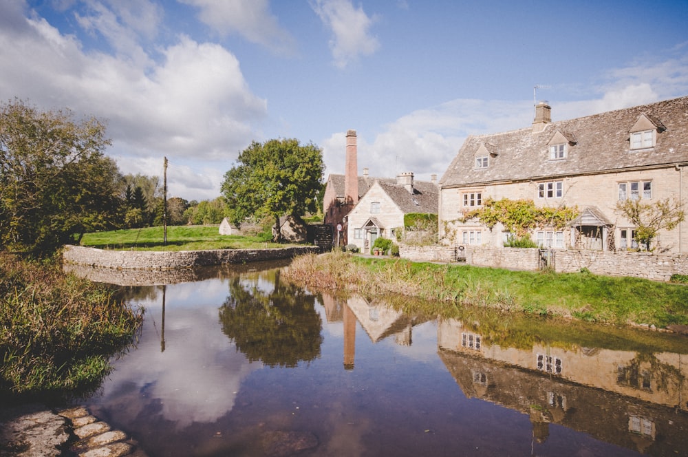 houses near pond during daytime