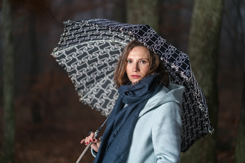 woman holding black umbrella