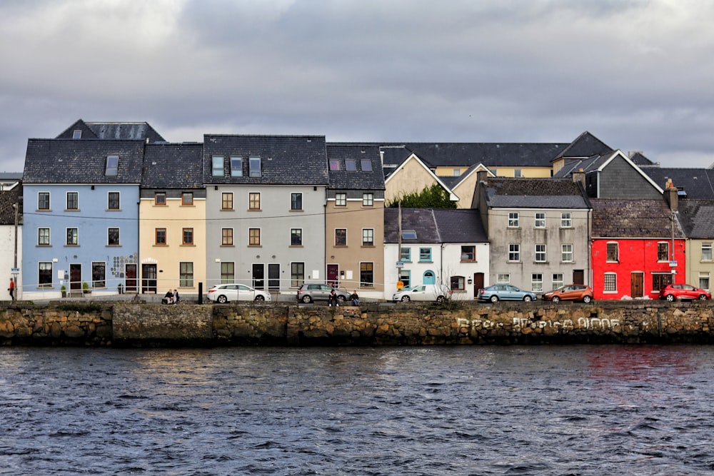 a row of houses next to a body of water