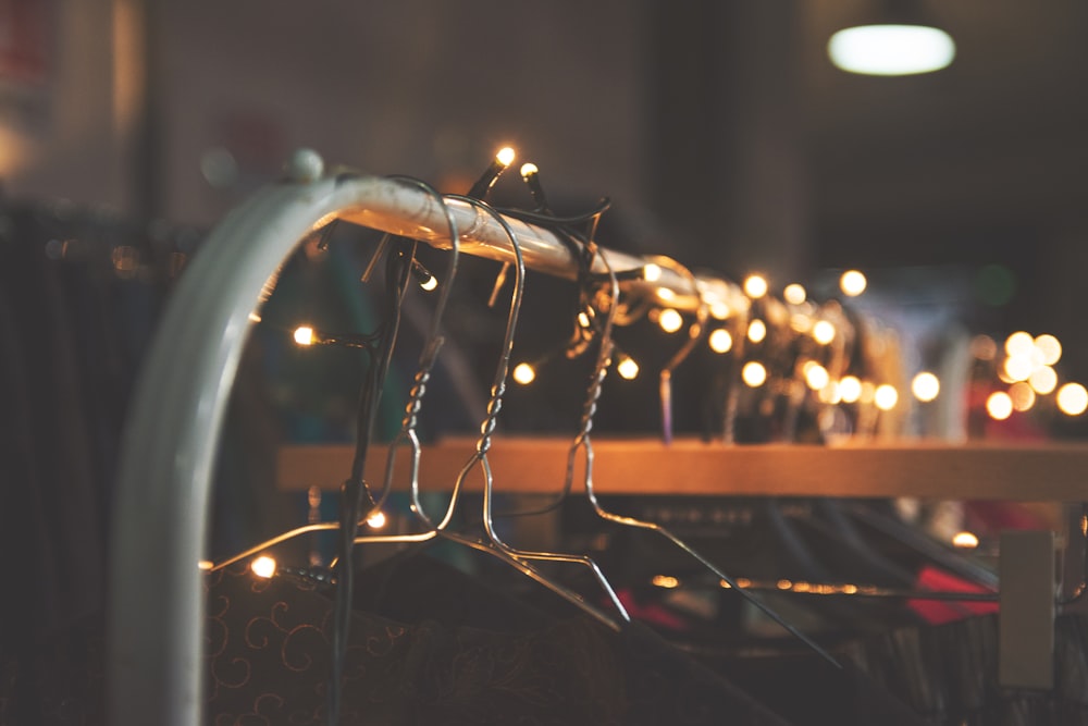silver clothes hangers with string lights