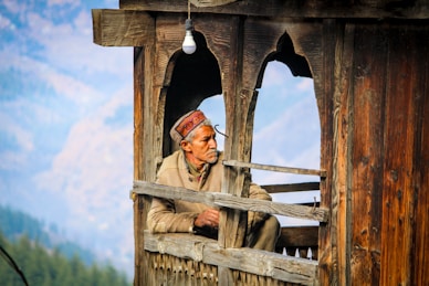 sitting man inside brown wooden building