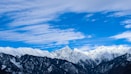 snow covered mountain under cloudy sky at daytime