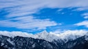 snow covered mountain under cloudy sky at daytime