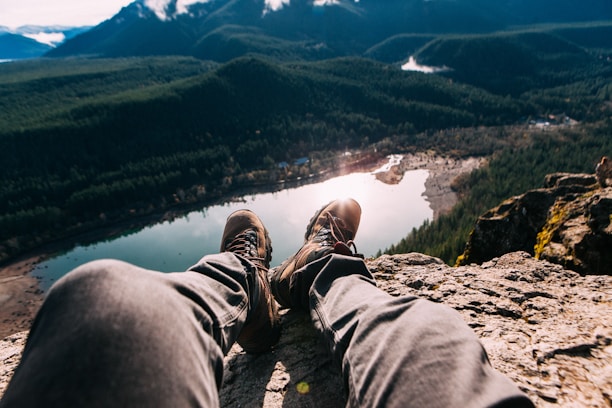 person sitting on mountain