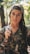 woman wearing realistic camouflage top and carrying rifle