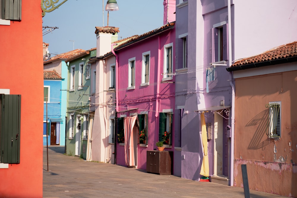 pink, purple, brown, and teal concrete buildings