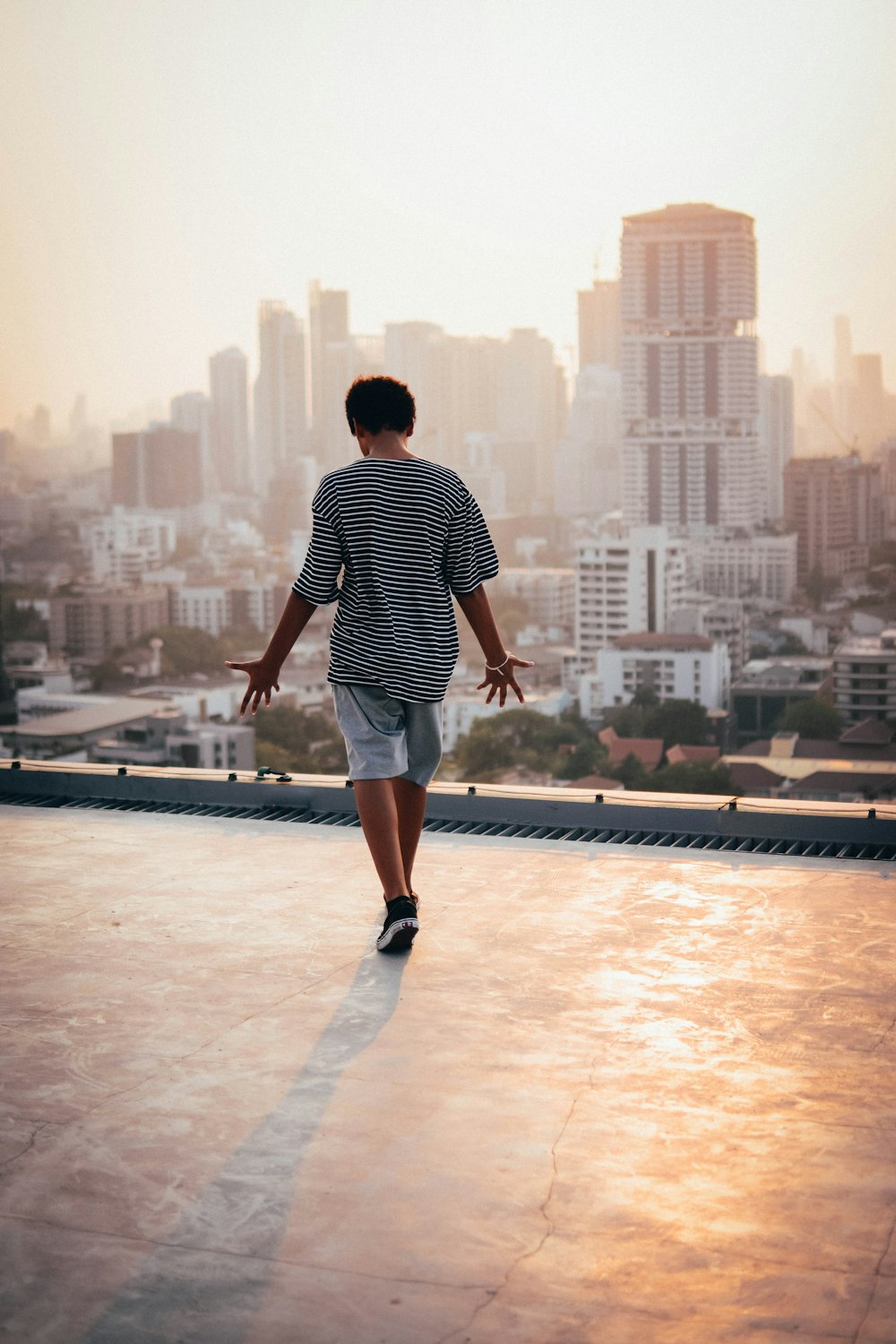 man standing on rooftop