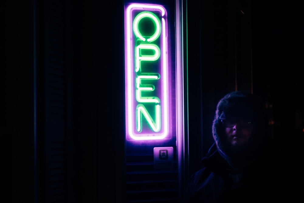 turned on purple and green open neon signage