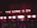 Neon lights display the phrase 'THE GAME IS ON' above a series of arcade machines. These machines are labeled 'ICE BALL' and display scores and numbers in bright colors. The setting appears to be a dimly lit arcade, creating an energetic and exciting atmosphere.