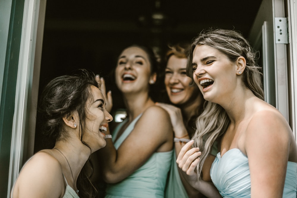 woman wearing teal tube dress while smiling