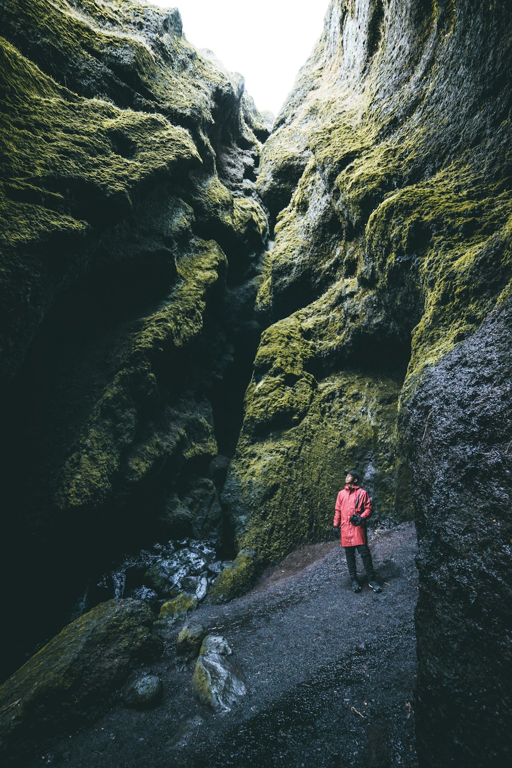 person standing between of hollow cliff