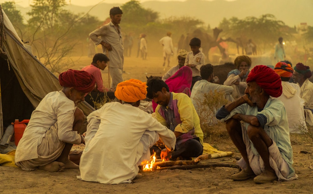 people sitting near bonfire